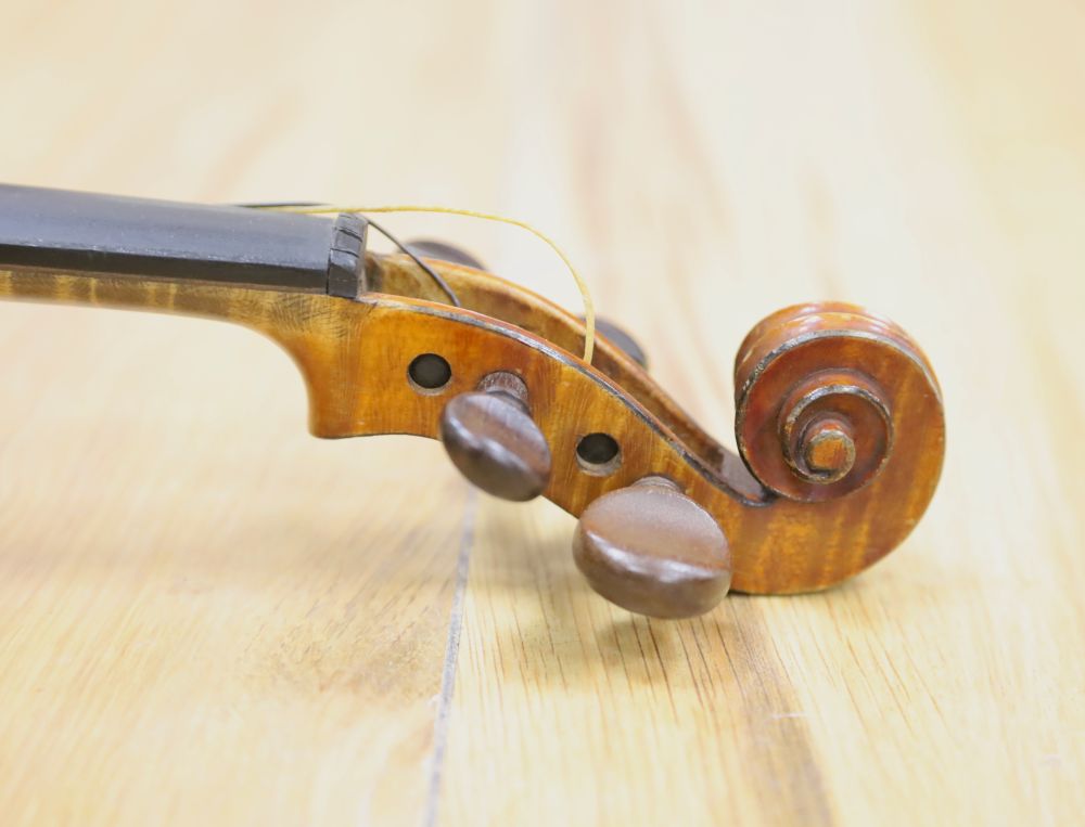 A late 19th century French 1/4 size violin, unlabelled, cased with a bow
